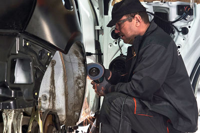 Mechanic repairing car