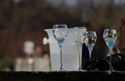 Close-up of wine glasses on table