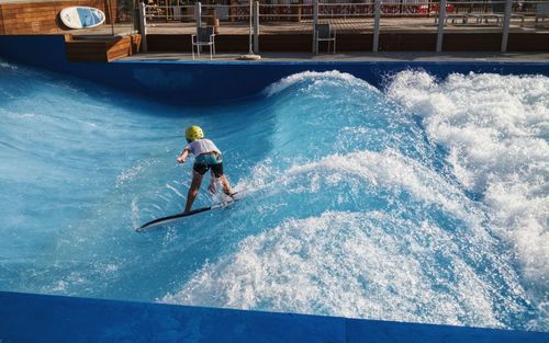 High angle view of boy surfing in swimming pool