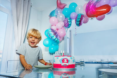 Portrait of boy playing with balloons