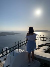 Rear view of woman looking at sea against sky