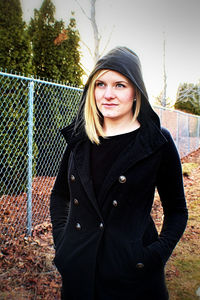 Portrait of beautiful young woman standing outdoors