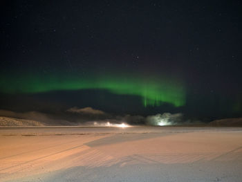 Scenic view of landscape against sky at night during winter