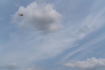 Low angle view of airplane flying in sky