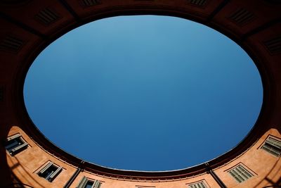 Low angle view of building against clear blue sky