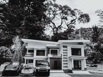 View of building and trees against sky