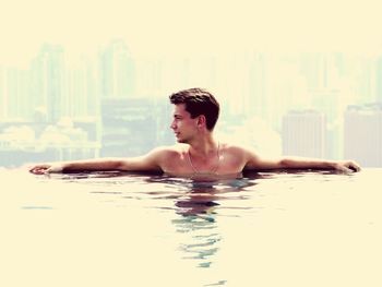 Shirtless young man in swimming pool