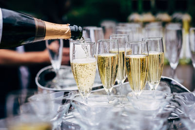 Wine pouring in glasses on table in restaurant