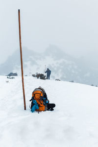 Adult man hiking in pico ruivo footpath covered with snow in santana, madeira island