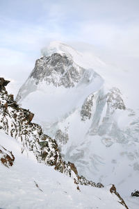 Scenic view of snow covered mountain against sky