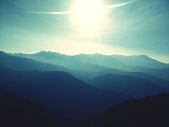 Scenic view of mountains against bright sky