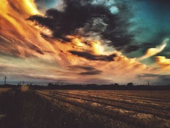 Scenic view of field against sky at sunset