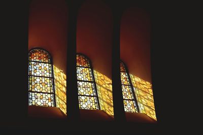 Low angle view of stained glass window in church