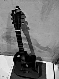 Close-up of guitar against wall