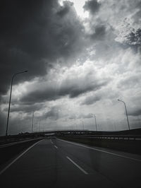 View of highway against cloudy sky