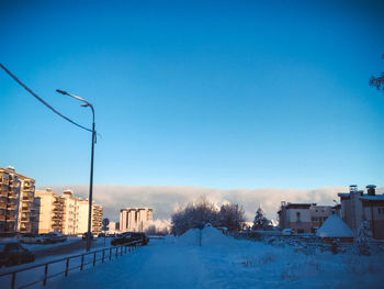 Buildings in city against clear blue sky