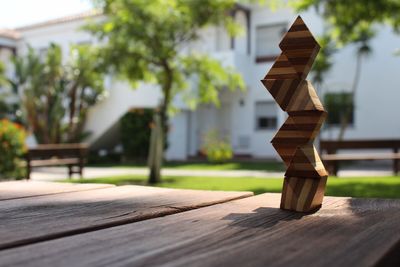 Close-up of stacked wooden blocks on table outdoors