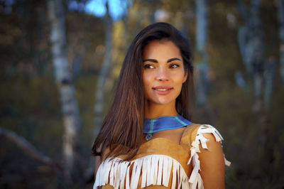 Young woman in traditional clothing looking away