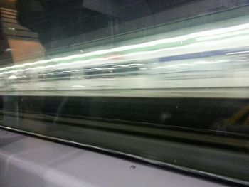 Blurred motion of train at railroad station