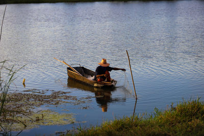 Man sitting on boat in lake