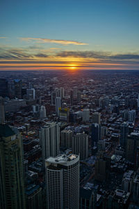 Aerial view of city against sky during sunset