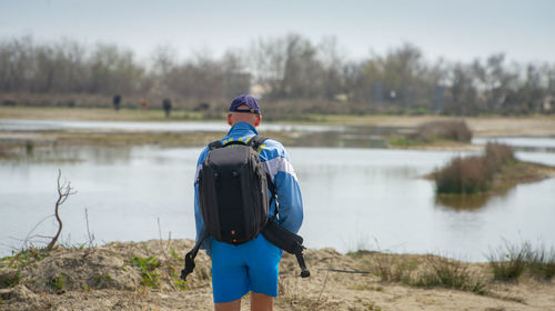 Rear view of man standing in lake