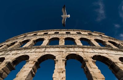 Low angle view of historical building against blue sky