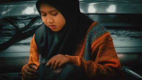 Girl looking away while sitting in car