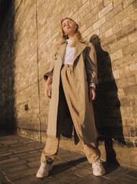 Woman standing against wall