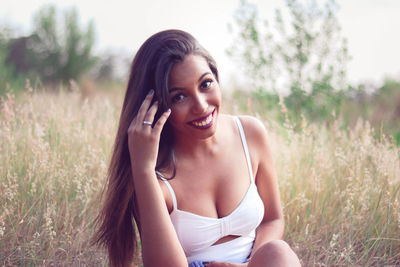 Portrait of smiling young woman in grass