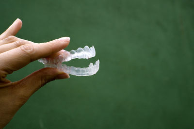 Close-up of hand holding dentures