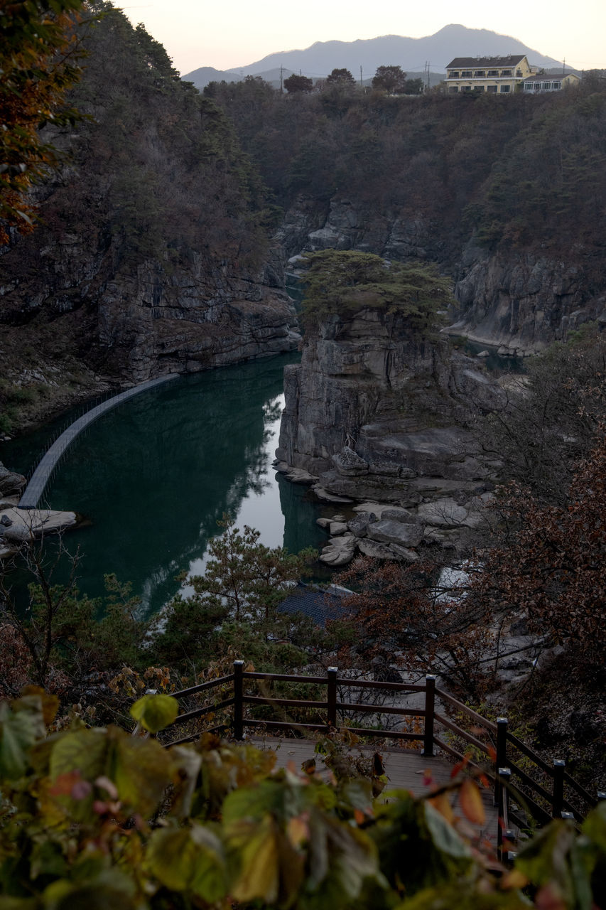 water, mountain, nature, environment, scenics - nature, beauty in nature, landscape, land, plant, travel destinations, tree, no people, travel, rock, non-urban scene, tourism, outdoors, lake, tranquility, sky, forest, tranquil scene, mountain range, wilderness, terrain, architecture, day, water feature, valley, canyon, rock formation, geology