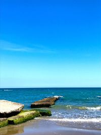 Scenic view of sea against clear blue sky