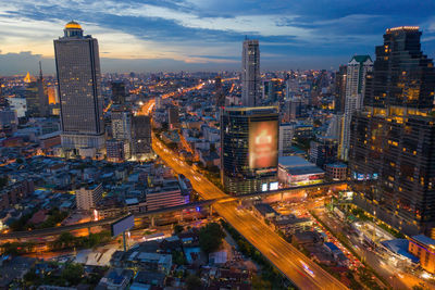 High angle view of illuminated city buildings at dusk