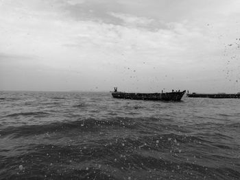 Boat sailing in sea against sky
