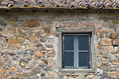 Low angle view of window on old building