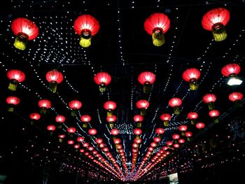 Low angle view of illuminated lanterns hanging at night