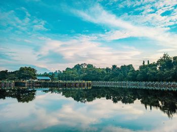 Scenic view of lake by trees against sky