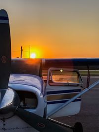 Close-up of car against sky during sunset