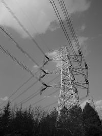 Low angle view of electricity pylon against sky