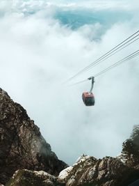 Low angle view of ski lift against sky