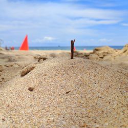 Close-up of sand on beach against sky