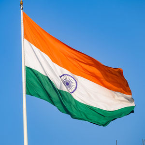 India flag flying high at connaught place with pride in blue sky, india flag fluttering, indian flag