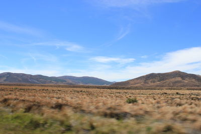 Scenic view of arid landscape against sky