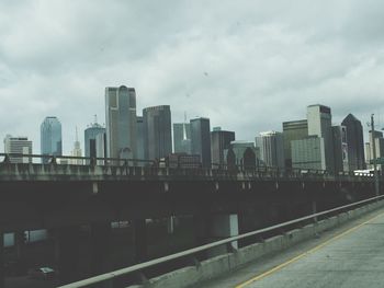 Buildings against cloudy sky