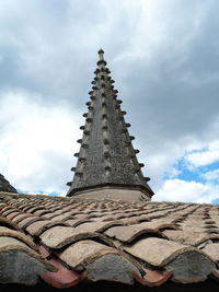 Low angle view of cross on building against sky