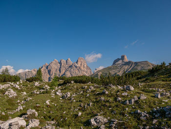 Scenic view of mountains against blue sky