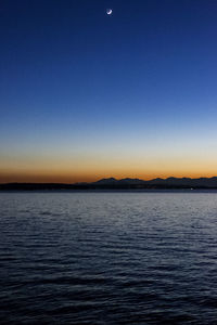 Scenic view of sea against clear sky during sunset