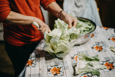 Midsection of man preparing food on table