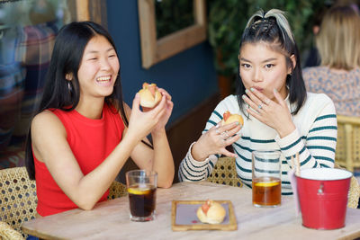 Portrait of young woman having food at restaurant